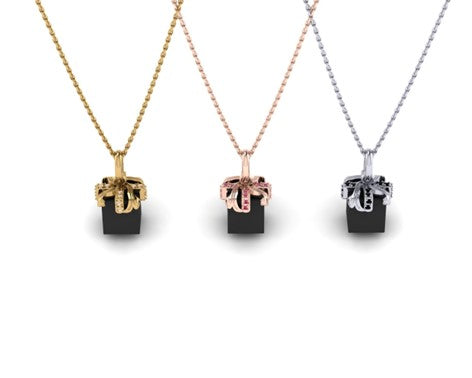 For Love: Charm of Gold and Diamonds Wrapped Around a Polished, Black Spinel Gift Box