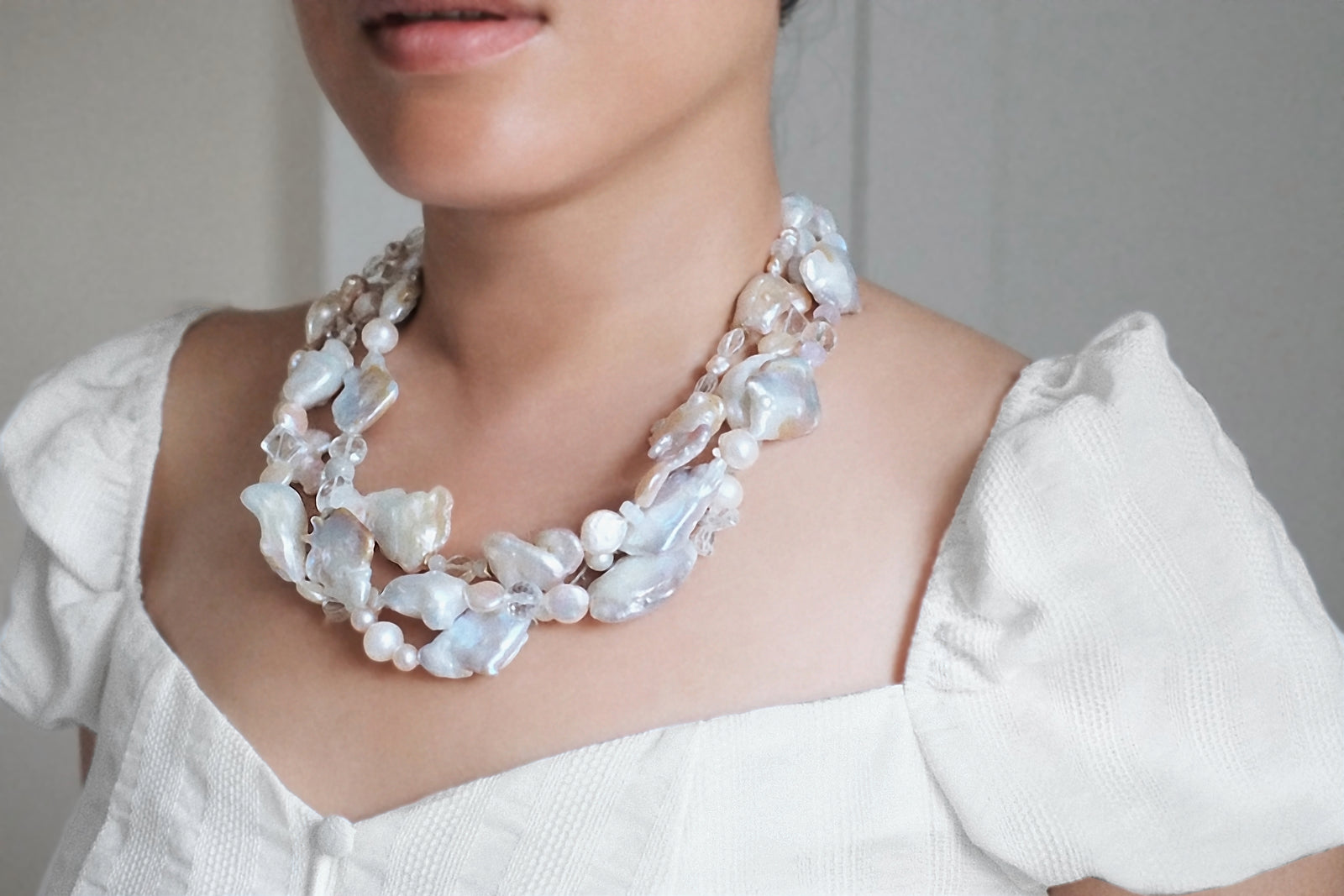 Charming: A Three Strand Necklace of Freshwater Pearls and Faceted Clear Crystals