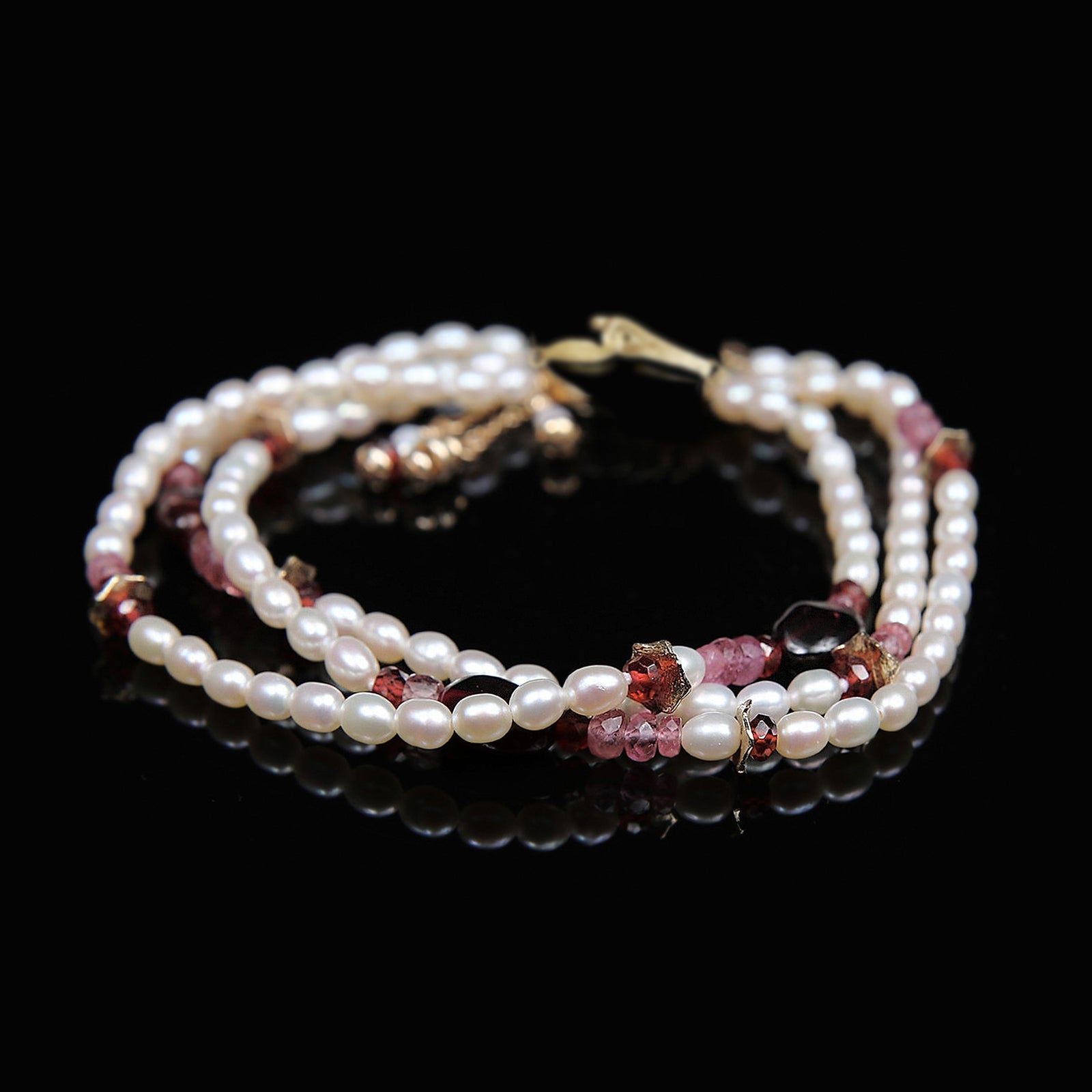 Charming: A Bracelet of Frreshwater Pearl, Pink Tourmaline, Rubies, Garnet, and Gold