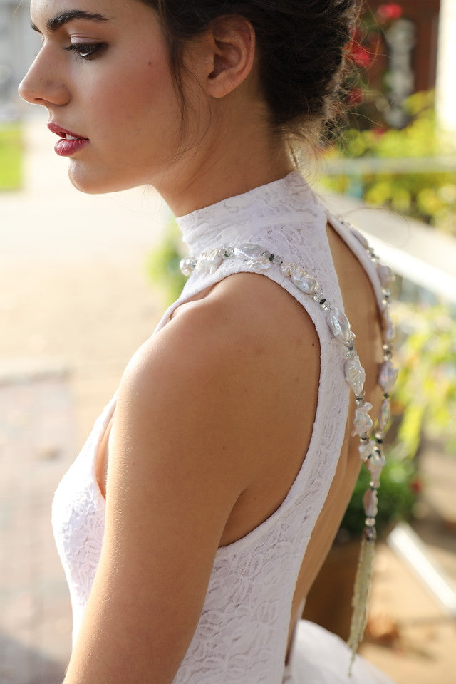 Sterling silver. Gems: pearl, prasiolite, sapphire, and cat's eye chrysoberyl. White Orchid Studio’s floral bead cap. Approximate length 45."