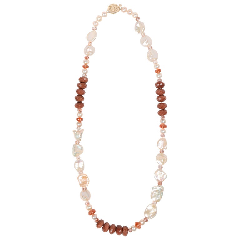 Princess necklace. Gem necklace of Keshi and button freshwater pearls, sunstone, goldstone, and strawberry quartz. WOS 14kt yellow gold logo clasp.