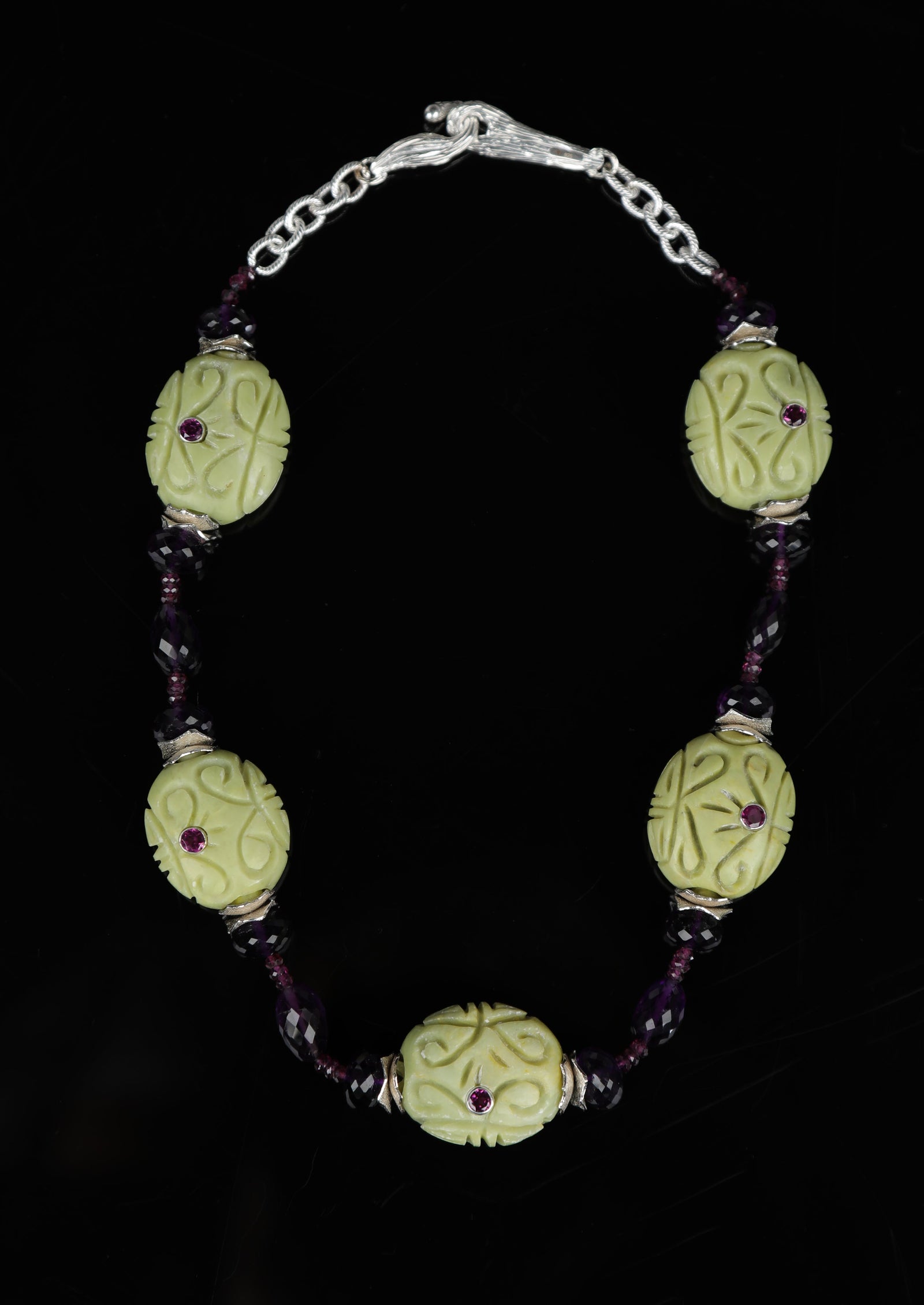 Sterling silver: textured silver chain. Gems: Mojave turquoise, Malaya and almandine garnet, and amethyst. White Orchid Studio’s vanilla bean clasp and wave spacers. Approximate length: 19.5”