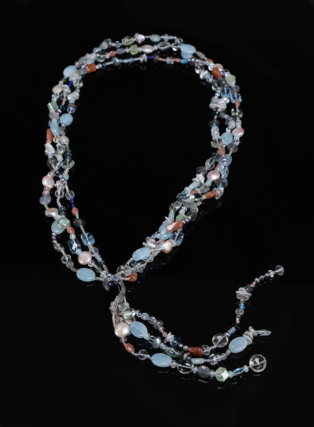 Sterling silver.  Gems: blue topaz, moonstone, aquamarine, pearls, apatite, and sapphires. Peggy Herrman Fine Jewelry's vanilla bean 
lariat set deep blue sapphires. Approximate lengths 26” + 8" for the tassel.
