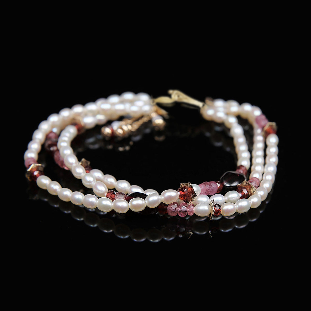 Charming: A Bracelet of Frreshwater Pearl, Pink Tourmaline, Rubies, Garnet, and Gold