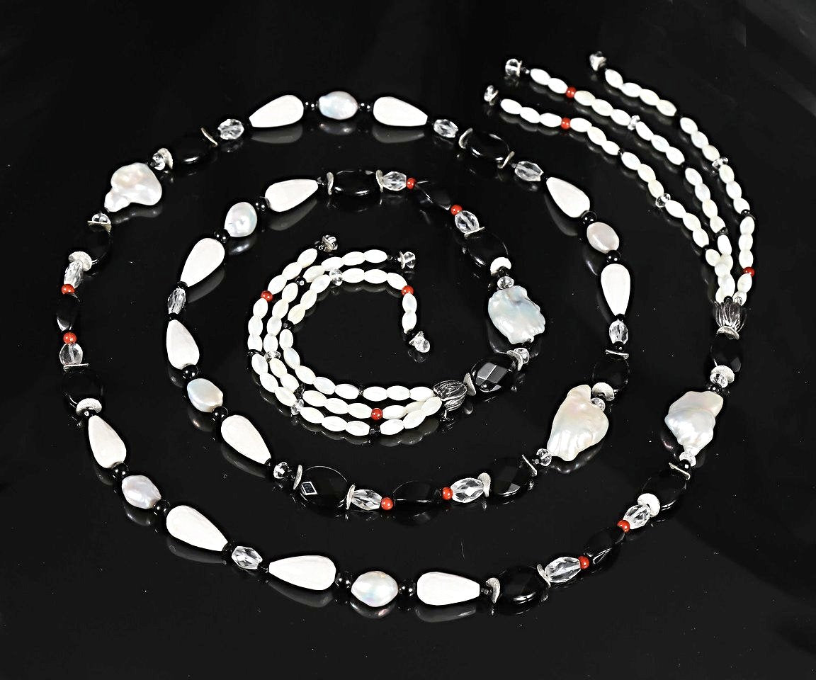 Sterling silver.  Gems: pearl, onyx, agate, quartz, and jasper. White Orchid Studio’s floral bead cap.  Approximate length 56.”