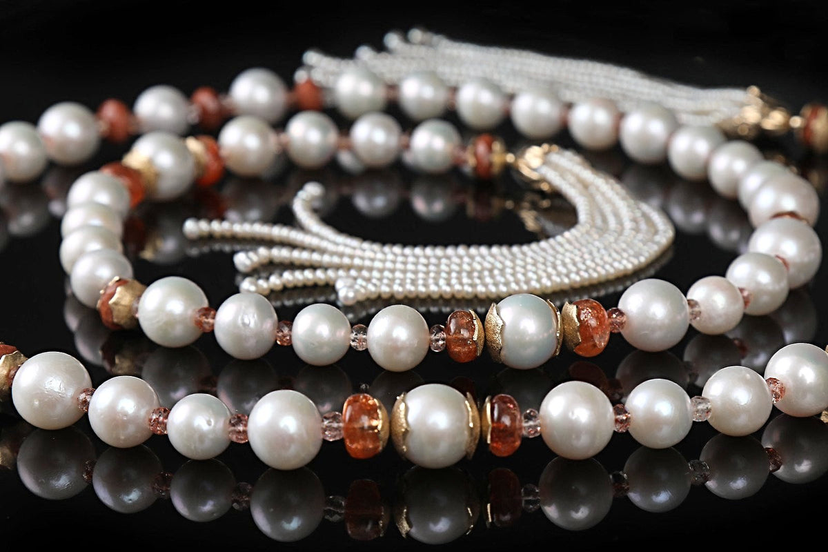 14kt yellow gold.  Gems: pearl (12-16 mm), button pearl (3mm), sunstone, and goldstone.  White Orchid Studio’s floral bead caps and spacers.  Approximate length:  56”