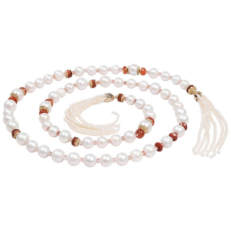 14kt yellow gold.  Gems: pearl (12-16 mm), button pearl (3mm), sunstone, and goldstone.  White Orchid Studio’s floral bead caps and spacers.  Approximate length:  56”