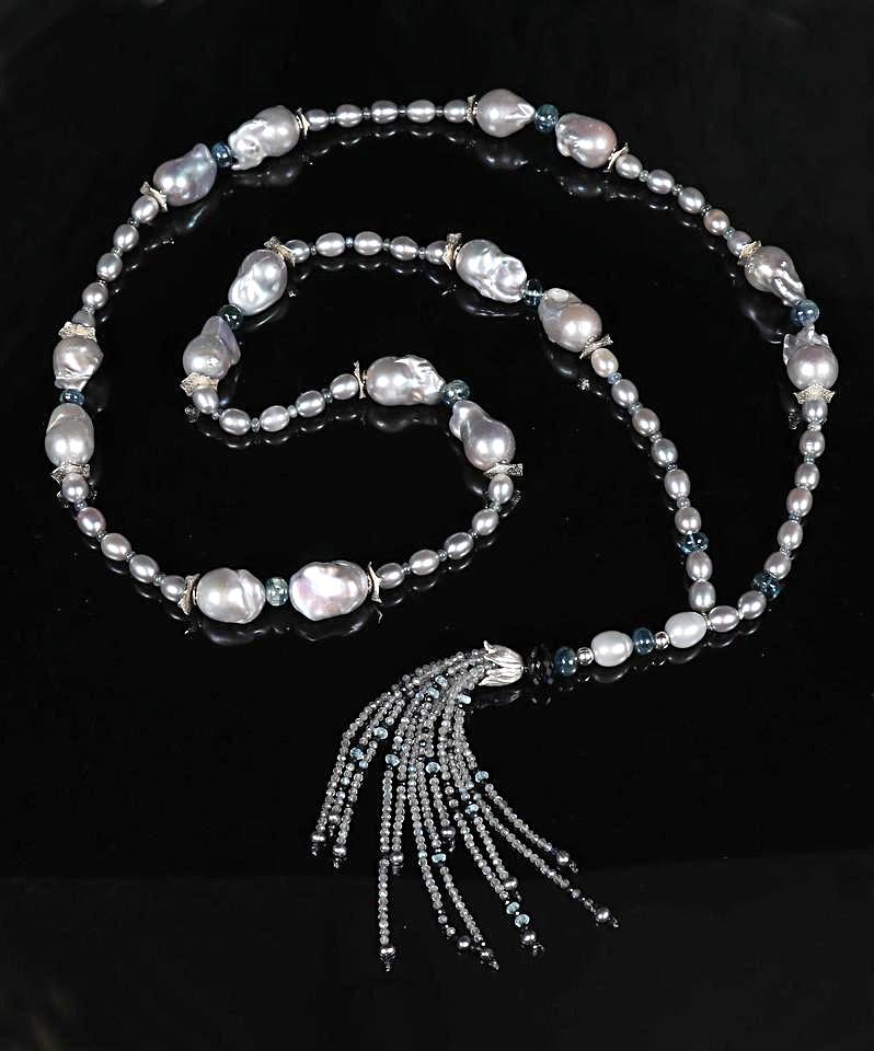 Sterling silver.  Gems: freshwater pearl (baroque and rice shapes), kyanite, teal to blue sapphires, topaz, and labradorite.  White Orchid Studio’s spacers and floral bead cap.  Approximate length 45.5."  