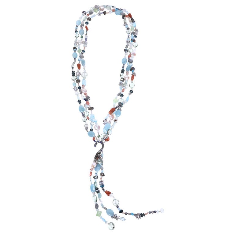 Sterling silver.  Gems: blue topaz, moonstone, aquamarine, pearls, apatite, and sapphires. Peggy Herrman Fine Jewelry's vanilla bean lariat set deep blue sapphires. Approximate lengths 26” + 8" for the tassel.